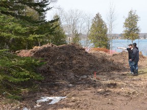 Nick Oldrieve points out over a property on East Bayshore Road in Owen Sound on Friday that has been excavated in the search for clues into the disappearance of Lisa Maas. (Rob Gowan The Sun Times)