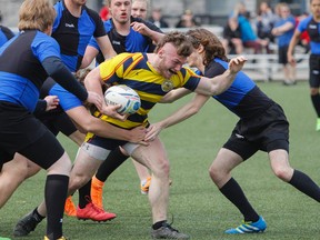 Napanee Golden Hawks’ Anthony Collins breaks the tackle against the Kingston Blue Raiders during the first half of the Kingston Area Secondary Schools Athletic Associations senior boys rugby game at the Nixon Field, in Kingston, Ont., on Friday, April 27, 2018. The Golden Hawks won 36-5.