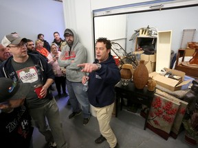 Bill Welychka auctions off a storage unit at CaraCo Storage Solutions in Kingston. The storage facility annually auctions off forfeited units to raise money for March of Dimes. (Meghan Balogh/The Whig-Standard/Postmedia Network)