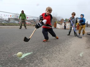 A handful of children played street hockey on Charles Street on Sunday during a special play-streets event, organized by Kingston Gets Active, Calvary United Church and the Skeleton Park Arts Festival. (Meghan Balogh/The Whig-Standard/Postmedia Network)
