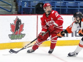 Cordel Larson of the Notre Dame Hounds and Mathieu Bergeron of the Magog Cantonniers battle for the puck during Telus Cup gold medal game action in Sudbury, Ont. on Sunday April 29, 2018. Notre Dame defeated the Cantonniers de Magog 5-1.Gino Donato/Sudbury Star/Postmedia Network