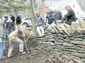 BRUCE BELL/THE INTELLIGENCER
John Scott (with sledgehammer) of Dry Stone Canada, gives instruction to the Morrison Point Dry Stone Wall team on Saturday morning in southern Prince Edward County. The group is learning how to repair portions of the wall along Morrison Point Road that have fallen into disrepair.