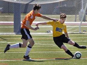 Ethan Andrew of North Park Collegiate moves in on Carter McAuley of Brantford Collegiate Institute during a high school boys soccer match on Monday at Bisons Alumni North Park Sports Complex. (Brian Thompson/The Expositor)