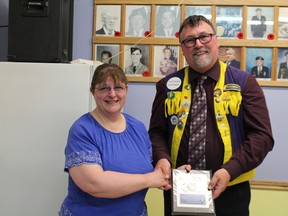 Daniel Touchette presents Fran Prior with a plaque for her dedicated service to the Cochrane Lions Club with her organizing the appointments for over 400 patients at the CNIB Eye Van.