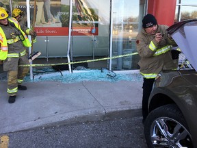 Police and fire crews clean up after a car went through the front doors of the McNaughton Avenue Shoppers Drug Mart on Saturday evening, breaking the glass on the front doors. No one was seriously hurt.