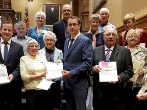 Progressive Conservative MPPs Jeff Yurek, left, Monte McNaughton and Bob Bailey, are pictured with citizens from Dutton Dunwich, Wallaceburg and North Stormont in eastern Ontario as they receive petitions with more than 3,000 signatures to present them in Queen's Park on Monday, April 30, 2018. (Handout/Chatham Daily News)