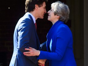 Canadian Prime Minister Justin Trudeau is officially welcomed to the Commonwealth Heads of Government Meeting by Britain’s Prime Minister Theresa May in London on Apr. 19.