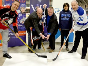 United Way Centraide North East Ontario executive director Michael Cullen, centre left, and Timmins Mayor Steve Black prepare to drop the puck between Rouyn-Noranda Huskies coach and general manager Gilles Bouchard and Sudbury Wolves vice president of hockey operations and general manager Rob Papineau during a press conference at the McIntyre Arena Tuesday morning. The press conference was to announce an exhibition contest between the two clubs at the McIntyre Arena on Friday, Sept. 14, to raise funds for the United Way and Bell Let’s Talk program.  THOMAS PERRY/THE DAILY PRESS