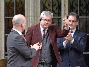 NDP MP Charlie Angus holds a feather as he rises to vote in favour of the NDP's motion calling on the House of Commons to officially ask the Pope to apologize to residential school survivors, on Parliament Hill in Ottawa, Tuesday.
CP Photo