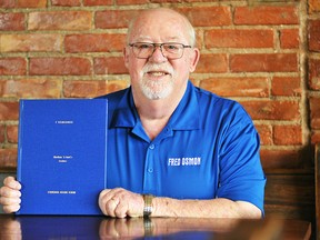 Fred Osmon is shown with his new book, I Remember: Chatham 'N Kent's Leaders, at the William Street Cafe. Tom Morrison/Chatham This Week