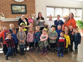 Child's World Daycare brought a group of kids over to Harvest Lodge to say thank you as Shirley Shmyr (In white, back row) handed over a cheque for $1,000 for the daycare and Lynette Schultz (dark blue, beside Shmyr) wrote out a cheque for a smaller amount. The two hope their donations will spur others to open their hearts and chequebooks to support the daycare.