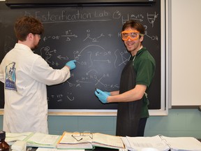 St. Benedict student Matthew McDonald learns about chemistry with former student Jarvis Hill during a chemistry esterification lab. Supplied photo