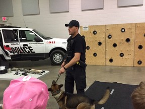 Woodstock police dog Striker, with his handler Const. Dan Skillings, teach local students about the dangers of alcohol and drugs at the Racing Against Drugs event at Oxford Auditorium Wednesday. (HEATHER RIVERS/SENTINEL-REVIEW)