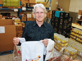 On Tuesday, May 1, 2017, Sandy Singers, executive director at Partners in Mission Food Bank, holds up one of the many collection bags that will be handed out this Saturday at nine local grocery stores as part of the annual Food Blitz in Kingston. Julia McKay/The Whig-Standard