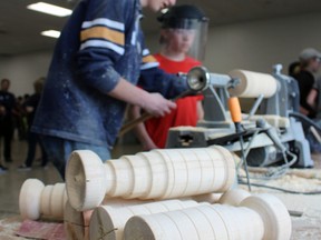 Grade 12 St. Mike’s student Mackenzie Campbell helps Grade 7 students make mini Stanley Cups with a wood lathe at a skilled trades workshop on Wednesday, May 2, 2018 in Mitchell, Ont. (Terry Bridge/Stratford Beacon Herald/Postmedia Network)