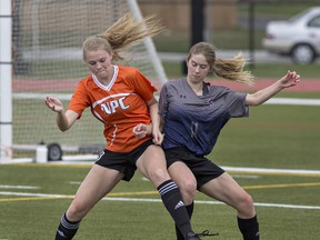 Amber Leggett (left) of North Park Collegiate and Sarah Jean Stark of Assumption College vie for the ball during a high school girls soccer match on Wednesday at Bisons Alumni North Park Sports Complex in Brantford. (Brian Thompson/The Expositor)