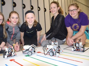 Paige Stevenson, Sabrina Ruetz, Lola Johnston, Shawna Schuit and Haley Brough line up with robots created by themselves and other Grade 7/8 students from F.E. Madill Secondary School in Wingham. The Township of Huron-Kinloss supported the initiative with funding made available through the Nuclear Waste Management Organization (NWMO) program called Early Investment in Education and Skills. The smiles on the girls’ faces attest to the fun and enjoyment they are having as they explore science and technology together with their robotic pals. (Shared photo)