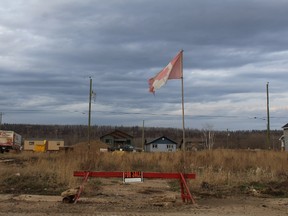 A Canadian Flag flutters outside an empty lot being sold in Waterways in Fort McMurray, Alta. on Monday, April 30, 2018. Vincent McDermott/Fort McMurray Today/Postmedia Network