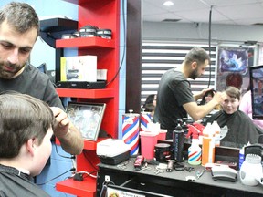 Legendary Barbershop’s Manni Al gets started on 11-year-old Jacob Fuchs-Nickel’s hair. The shop donated their time and all funds from $7 haircuts to Fort High’s Sting football team on April 28 and 29.