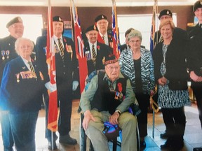 D-Day veteran Albert Carr, seated centre with wife Dorothy, standing centre, now is a member of the French Legion of Honour. Joining him at a presentation ceremony, son James, left; Betty Kennedy, Legion zone service officer; Morgan Kennedy, Marg Sharpe, Robert White, Nancy Miller and Art Mayo (both partly hidden), Legion Branch 410 colour guard; EML MP Karen Vecchio and great-grandson Sam Lambert. (Contributed photo)