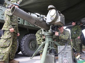 Cadets from the Royal Military College of Canada look at a TOW missile launcher while during a stopover by members of the Royal Canadian Regiment during an exercise ahead of its deployment to Latvia in July in Kingston, Ont. on Thursday, May 3, 2018. 
Elliot Ferguson/The Whig-Standard