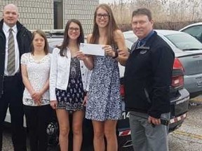 Sisters earn praise for their Snacks for Summer  program from the Sarnia Police.The Sarnia Police Association donated $500 towards the program. From left are Det. Jim MCabe, the Vrolyk sisters Sydney, Abby, Paige and Det.Const. Mike Hart.Submitted Photo