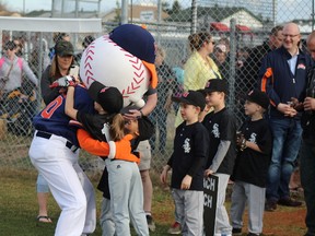 Members of the White Sox coach pitch team hug mascot O'Gee as they enter the field at the Fort McMurray Minor Baseball Association 2018 opening ceremonies at Ron Morgan Park in Fort McMurray, Alta. on May 2, 2018. Laura Beamish/Fort McMurray Today/Postmedia Network