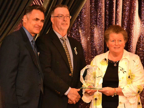 Stratford-Perth YMCA CEO Mimi Price (right) and board chair Kevin Britton (left) accept the non-profit/charitable award from Jack Walsh (centre) of Wightman Telecom at the 2018 Business Excellence Awards Thursday night. Galen Simmons/The Beacon Herald/Postmedia Network