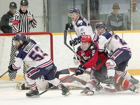 Backchecking Cochrane Crunch forward Nicholas Flanders takes down an unidentified member of the Wellington Dukes in front of a sprawled goalie Taylor Unruh during a  Dudley-Hewitt Cup game at the Dryden Memorial Arena on Thursday. Flanders’ teammates Austin Whelan, left, and Noah Bennett a following the path of the puck on the play. The Crunch dropped a 6-3 decision to the Dukes, to fall to 0-3 in round-robin action and they were eliminated from the tournament. The Dukes will meet the Thunder Bay North Stars on Friday for the right to meet the host Dryden GM Ice Dogs in the championship game on Saturday.   TIM BATES/DHC/OJHL IMAGES