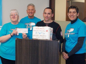 TP North Bay campaign founder Ellen  Barriage-Faulkner holds a $1,000 donation from committee member Michel Leboeuf, of Leboeuf and Associates Private Wealth Management (part of Investors Group), second from right, with fellow members Peter Gregory, second from left, and Angela Trudel-Johnston, right. Dave Dale / The Nugget