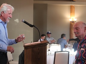 Host Dan Kroffat and Bearcat Murray share a moment at the podium before the dinner in Murray's honour at the RancheHouse last Friday.