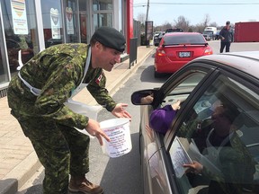 Col. Patrick Lemyre, the CFB Kingston Base Commander, solicits donations at the McDonald's drive-thru on the base on Wednesday May 2 2018, McHappy Day. In Kingston one dollar from the sale of every Big Mac, Happy Meal or McCafe beverage as well as solicited donations was donated to the Boys and Girls Club of Kingston and Area. Ian MacAlpine/The Whig-Standard/Postmedia Network