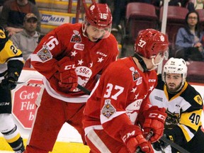 Soo Greyhounds Morgan Frost and Ryan Roth and Hamilton Bulldogs Ryan Moore scramble for the puck during the first period of Game 2 of the OHL championship at Essar Centre on May 5, 2018. (BRIAN KELLY/THE SAULT STAR/POSTMEDIA NETWORK)