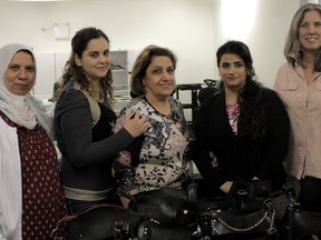 Wessam Ayad, from left, Nesrin Youssef, Sanaa Alani, Farah Kafrouhi and Carolyn Butts are seen in the Begin Again Group workshop at the Tett Centre, making handmade purses and bags out of recycled material. (Wyatt Brooks/For The Whig-Standard/Postmedia Network)