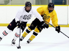 Team White's Lucas Rothe, left, fends off Team Yellow's Kobe Ferreira during the championship game at the Chatham Maroons' spring camp at Thames Campus Arena in Chatham, Ont., on Sunday, May 6, 2018. (MARK MALONE/Chatham Daily News/Postmedia Network)