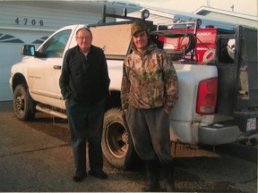 Graham (right) and Bernard Klemp standing beside Graham's work truck. (Submitted | Mark Klemp)