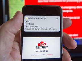 A smartphone and a television receive visual and audio alerts to test Alert Ready, a national public alert system Monday, in Montreal.THE CANADIAN PRESS/Ryan Remiorz