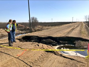 Fort Saskatchewan-Vegreville MLA Jessica Littlewood (left) surveys extensive road damage in Lamont County caused by flooding since the end of April.

Photo courtesy Jessica Littlewood