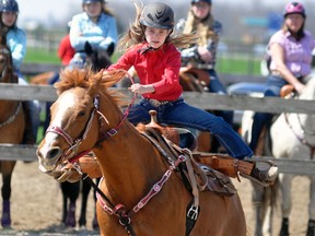 Jocelyn McNicholl literally flies out of her saddle as she rides in the under-13 barrels event at the first Mitchell Horse Club show of the season last Saturday, May 5 at the Moore Stables in Mitchell. Warm temperatures made the opening show much better than previous years, with future shows planned for June 2 and 16, July 7 and Aug. 11. ANDY BADER/MITCHELL ADVOCATE