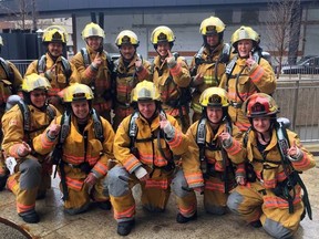 Whitecourt firefighters pose together in full duty gear before climbing the Bow Tower in Calgary on April 29 (Submitted | Whitecourt Fire Department).