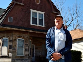 Henry Krygsman stands in front of the St. Thomas house he bought in 2002. He later repaired the foundation and has restored much of the structure to its former glory, work that won him a 2018 Architectural Conservancy of Ontario Heritage Award. (Louis Pin/Times-Journal)