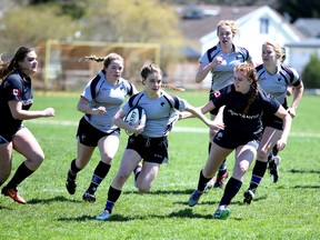 Jamey Cunningham finds a little gap in the St. Mary's Mustangs defence for the Owen Sound District Wolves. The Wolves beat the Mustangs, 41-10, at OSDSS on Monday afternoon in Bluewater Athletic Association action. Greg Cowan/The Sun Times