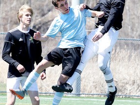Brad Patterson of the Confederation Chargers battles for the ball with Tony Piro of the St. Benedict Bears during senior boys high school soccer action in Sudbury, Ont. on Monday May 7, 2018. The Bears defeated the Chargers 2-0.Gino Donato/Sudbury Star/Postmedia Network