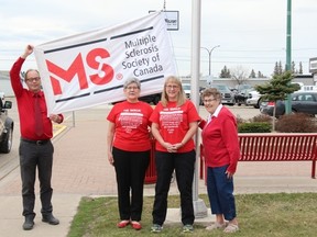 (L. to R.) Melfort Mayor Rick Lang is joined by Pat Dolo, Sandra Ryhorchuk and Phylis Sinclair to raise the MS flag declaring MS Month in the City of Melfort.