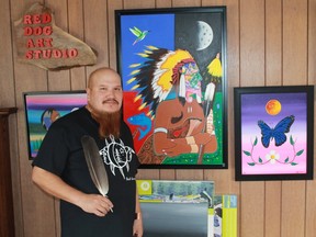 Ojibway artist Jeffrey 'Red' George stands in front of his self-portrait at his Port Franks Red Dog Art Studio.
CARL HNATYSHYN/SARNIA THIS WEEK