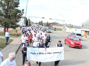 Local RCMP officers led the group of participants of the annual Walk a Mile in Her Shoes event on May 3.