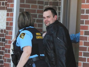 Patrick Carignan is led out by court security officers at the Superior Court of Justice in Cochrane Monday afternoon after being sentenced. Postmedia File Photo