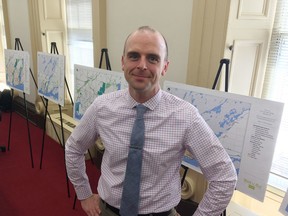 Ian Semple, Kingston's director of transportation services, stands in front of maps that outline the draft plan for the city’s active transportation master plan on Monday. (Elliot Ferguson/The Whig-Standard)
