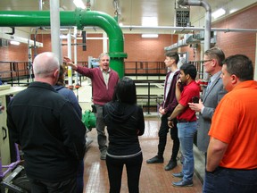 Garry Leathem, Director of Public Works for the Town of Fairview gestures at equipment in the Town's water treatment plant as he leads a tour for Rotary Club of Fairview members (from left: Kris Hvamb, Rotary guest Kirsten Knievel, Kristi Heck, Rotary exchange student Claudio dePalma, Sanket Bhutada, Chris Laue and Warren Murray.