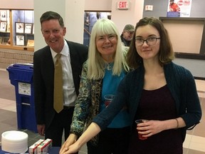 Carol Parsons, centre, recipient of Owen Sound's 2018 volunteer of the year award, and Nyah Way, who received the city's youth volunteer of the year award, join hands to cut a cake during a reception before Monday's council meeting. Owen Sound Mayor Ian Boddy, left, presented both women with their awards during the council meeting. DENIS LANGLOIS/THE SUN TIMES